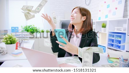 asian business woman excited with raining money
