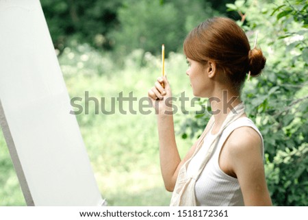 woman young easel on nature white canvas