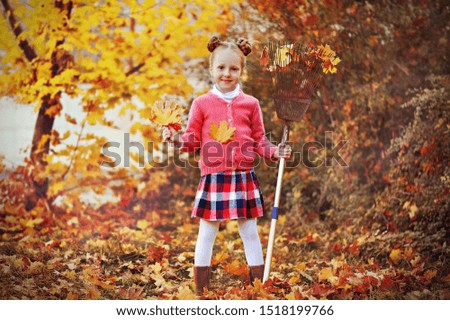 Full length picture of red haired girl collecting autumn leafs