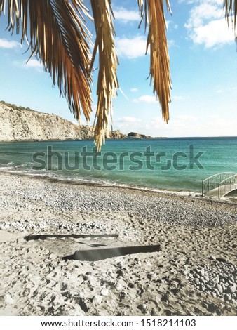 Turquoise Beach, Palm Leaves, Water Bridge, Rocks, Blue Sky and White Clouds 