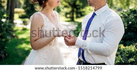 wedding rings and hands of bride and groom. young wedding couple at ceremony. Lovers put each other rings on the fingers.two happy people celebrating becoming family