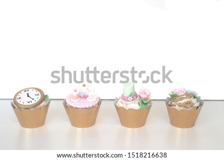 alice in wonderland cupcakes on white background