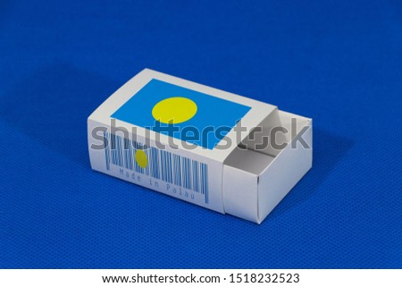 Palau flag on white box with barcode and the color of nation flag on blue background, paper packaging for put match or products. The concept of export trading from Palau.