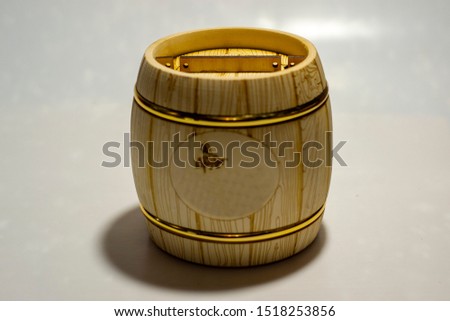 wooden barrel under honey on a white background
