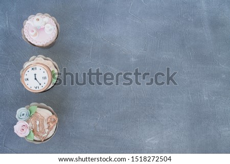 alice in wonderland cupcakes on grey background