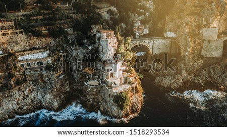 Top aerial view of famous fiordo di furore beach and bridge and his boats seen from birds eye in the beautiful Amalfi Coast in South Italy. Perfect wallpaper for drone and nature lovers. 