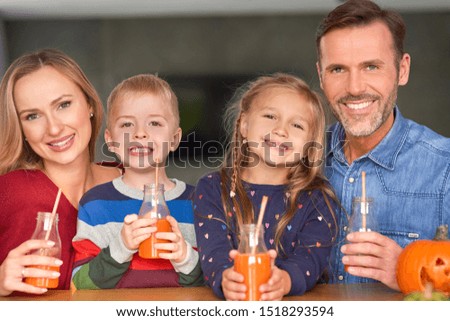 Portrait of smiling family drinking smoothie  