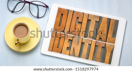 digital identity concept - word abstract in letterpress wood type on a tablet, flat lay with coffee and glasses, internet networking and online presence