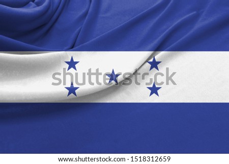 Realistic flag of Honduras on the wavy surface of fabric