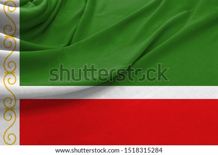 Realistic flag of Chechen Republic on the wavy surface of fabric