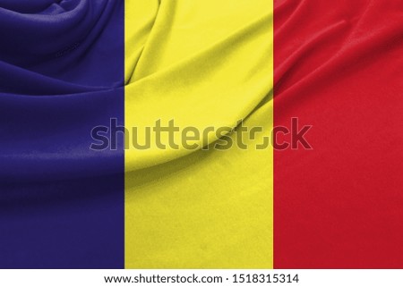 Realistic flag of Romania on the wavy surface of fabric
