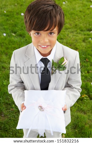 Page Boy Carrying Wedding Ring On Cushion Royalty-Free Stock Photo #151832216