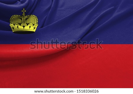 Realistic flag of Liechtenstein on the wavy surface of fabric