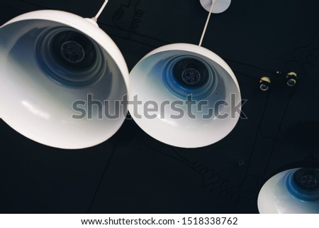 Close up of industrial style lamps decorated in a modern coffee shop. Royalty high quality free stock image of lamps. 