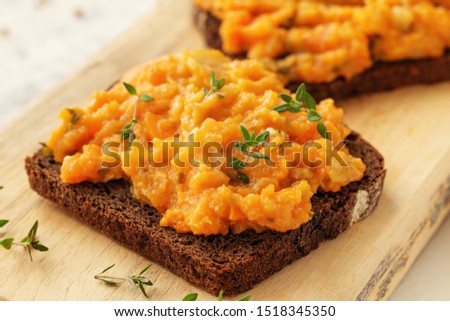 Bread with homemade caviar vegetables - squash, zucchini, tomatoes, onions, carrots, bell peppers and hot peppers  Royalty-Free Stock Photo #1518345350