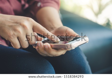 hipster woman using hands touching and typing on mobile phone screen search internet online working or social communication with digital 5G technology app device in coffee shop indoor lifestyle.