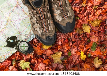 Hiking man shoes with classic compass and map