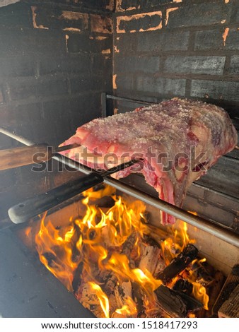 The meat seasoned with coarse salt, a culinary culture, roasted on a charcoal barbecue and fire on the metal grill. Cuts of meat are important for flavor success