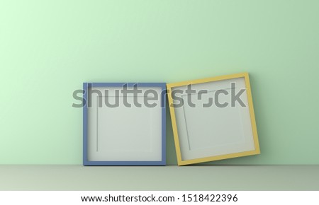 two colorful picture frame for insert text or image inside on pastel light green color wall. 