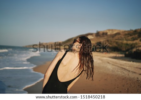 woman model in a swimsuit on the sea resting
