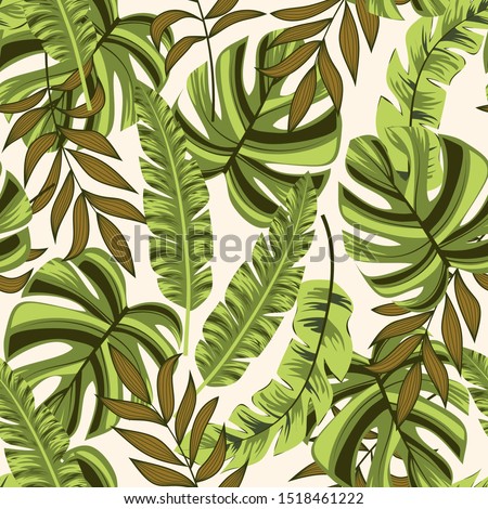 Trend seamless pattern with green tropical leaves on beige background. Illustration in Hawaiian style. Summer background with exotic leaves. Seamless vector texture.