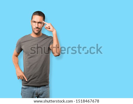 Serious young man doing a gesture of concentration