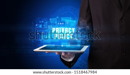 Young business person working on tablet and shows the digital sign: PRIVACY POLICY