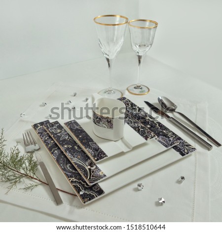 Set of clean tableware, dishes, plates, utensils, cups on the table