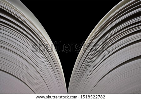 Open book with open pages on both sides. Isolated on black