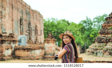 Young asian woman traveler traveling in Ayutthaya, Thailand. Travel concept.