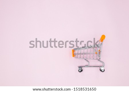 A cart on a pink background.