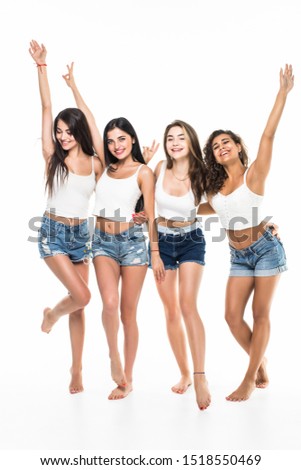 Full length portrait of a happy four girls pointing fingers at camera isolated on a white background