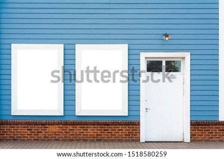 Blank white banner for advertisement on the colorful wall next to door