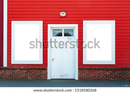 Blank white banner for advertisement on the colorful wall next to door