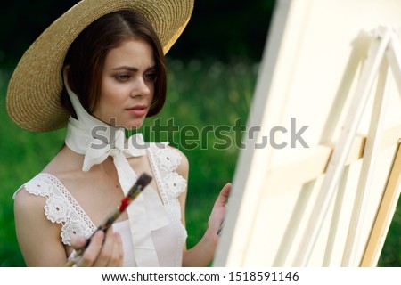 beautiful woman easel paints paints in the forest beautiful model