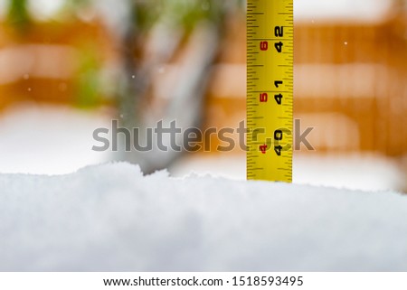 Measuring the snow depth with ruler 40 feet Royalty-Free Stock Photo #1518593495