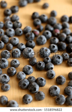 Pile of blueberries on a wooden table. Selective focus.