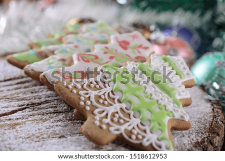 Colorful Christmas gingerbread in the shape of a Christmas trees decorated with color icing in a day light