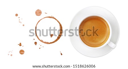 White cup full of espresso coffee on saucer, with brown circle coffee stains and drops isolated on white background, elevated top view, directly above Royalty-Free Stock Photo #1518626006