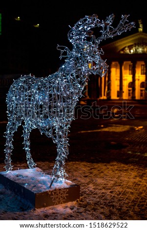 
The photo shows a close-up of a Christmas deer glowing, illumination. The picture was taken in winter.