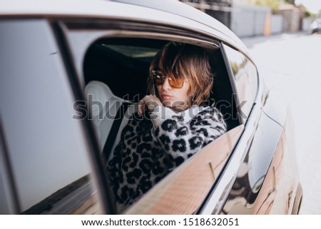 Young attractive woman sitting in car