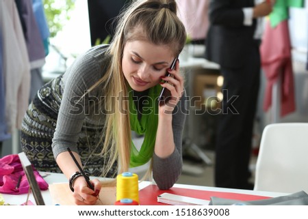 Fashion Clothes to Bespoke Designer Talking Phone. Busy Young Woman with Smartphone. Caucasian Seamstress Creating Sketch. Needlework Business Concept. Modern Stylist Inspirational Office