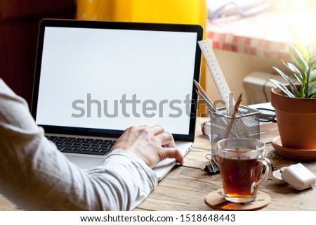 A man sits in front of a laptop. Business concept