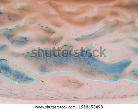 Aerialphoto of the Baltic sea beach. Azure waves, sand ridges, footprints in the sand
