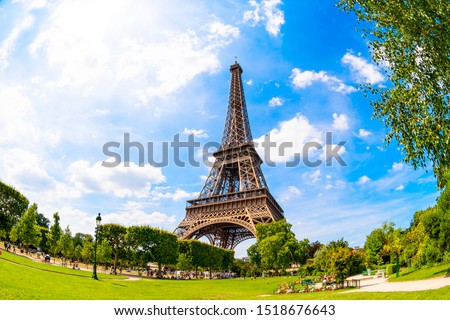 The Eiffel Tower in Paris on a beautiful summer day with blue sky in the background