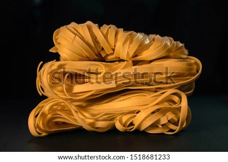uncooked pasta on black background