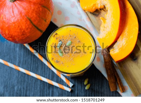 pumpkin smoothie in a glass with cinnamon