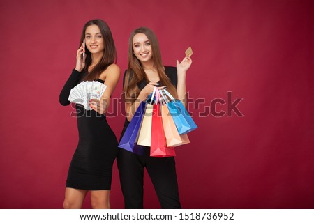 Shopping. Elegant brunette women wears black dress holding shopping bags, black friday concept