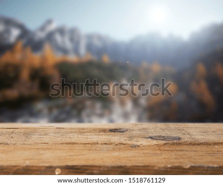Empty wooden table with autumn background.
