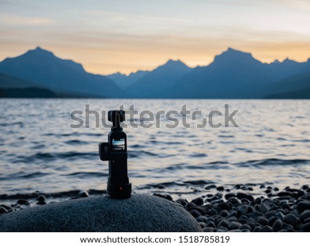 Camera taking picture of the beautiful sunrise of the Lake Mcdonald at Glacier National Park, Montana